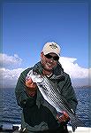 A guide from &quot;The Hook Up&quot; outfitters shows off a 5-lb. striped bass from Arizona's Lake Pleasant.