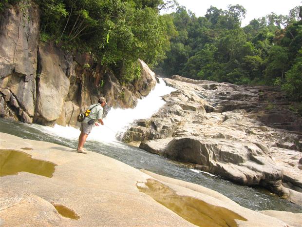 Fishing by the waterfall