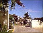 The haves and have nots. This image taken through the gate of a luxury resort on Corozal Bay in Belize was to show the contrast in wealth of the people. If you lived beyond this gate would you care if