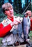 Guide shows off record Manbitoba grayling caught by Joe Reynolds. Largest grayling, by weight, ever caught in Manitoba. 4 pounds, 1 ounce. Taken on dry fly.