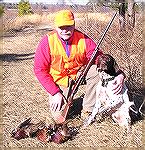 Me and my son's dog "Cody" after a pheasant hunt in early 2005. Note the old Remington Wingmaster. It dropped them just as clean as any of the new wizbang magnums.