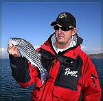 Ben Koller of &quot;The Hook Up&quot; outfitters holds up a typical school-sized striped bass from Arizona's Lake Pleasant. 