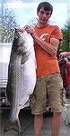 Tyler Shields,17, holds the new freshwater state record striped bass, a 66-pound fish caught from Hiwassee Reservoir in Cherokee County on March 31, 2012.